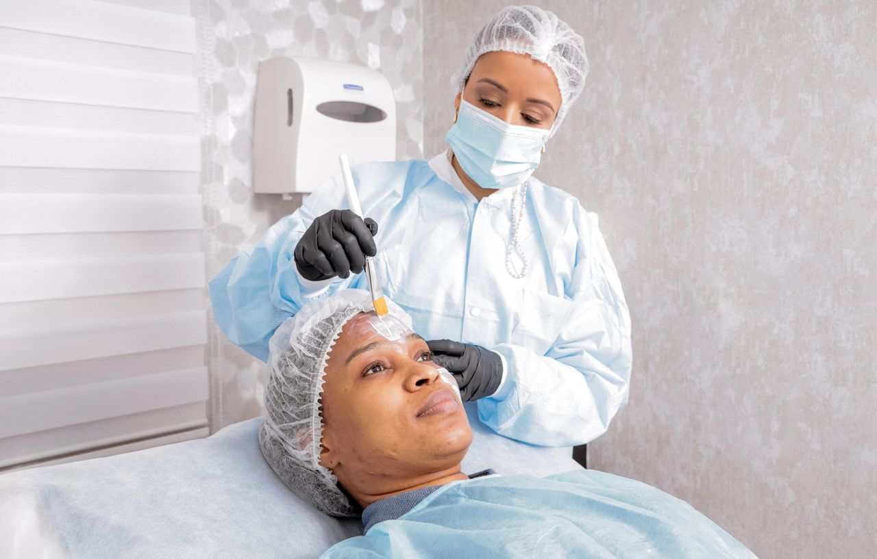 Mastering the First Impression: Your intriguing post title goes here A beautician applies a treatment to a womans face in a spa, focusing on skincare.