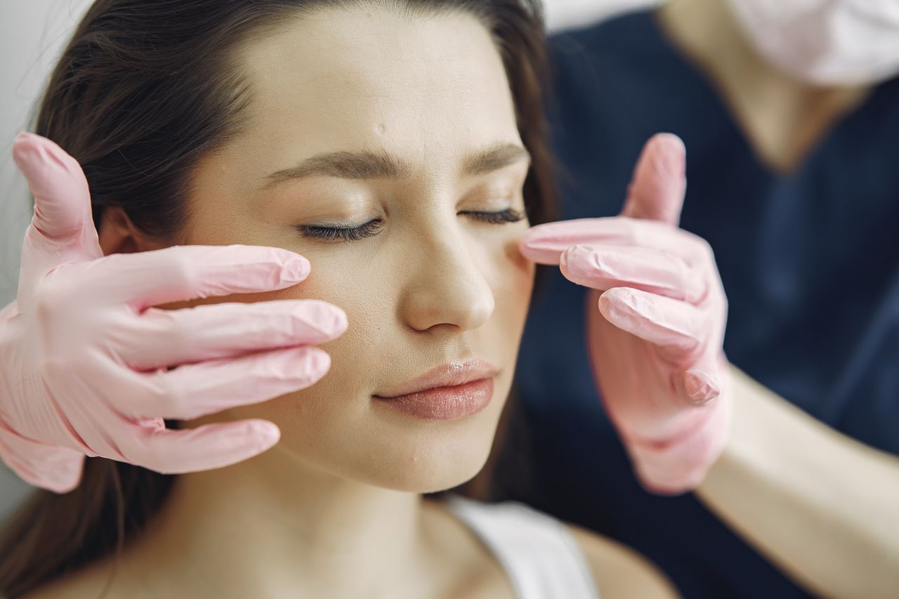 The Art of Drawing Readers In: Your attractive post title goes here Close-up of a woman with eyes closed receiving facial care in a beauty clinic indoors.